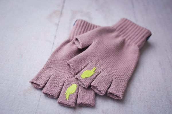 Two Pink Fingerless Gloves with a Lime colored bird on the middle finger stacked
